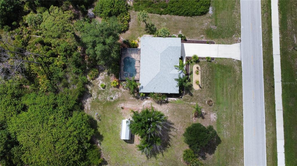 An aerial view shows a house with a pool, a driveway, and a detached shed — 5769 E PRICE BOULEVARD, NORTH PORT, FL