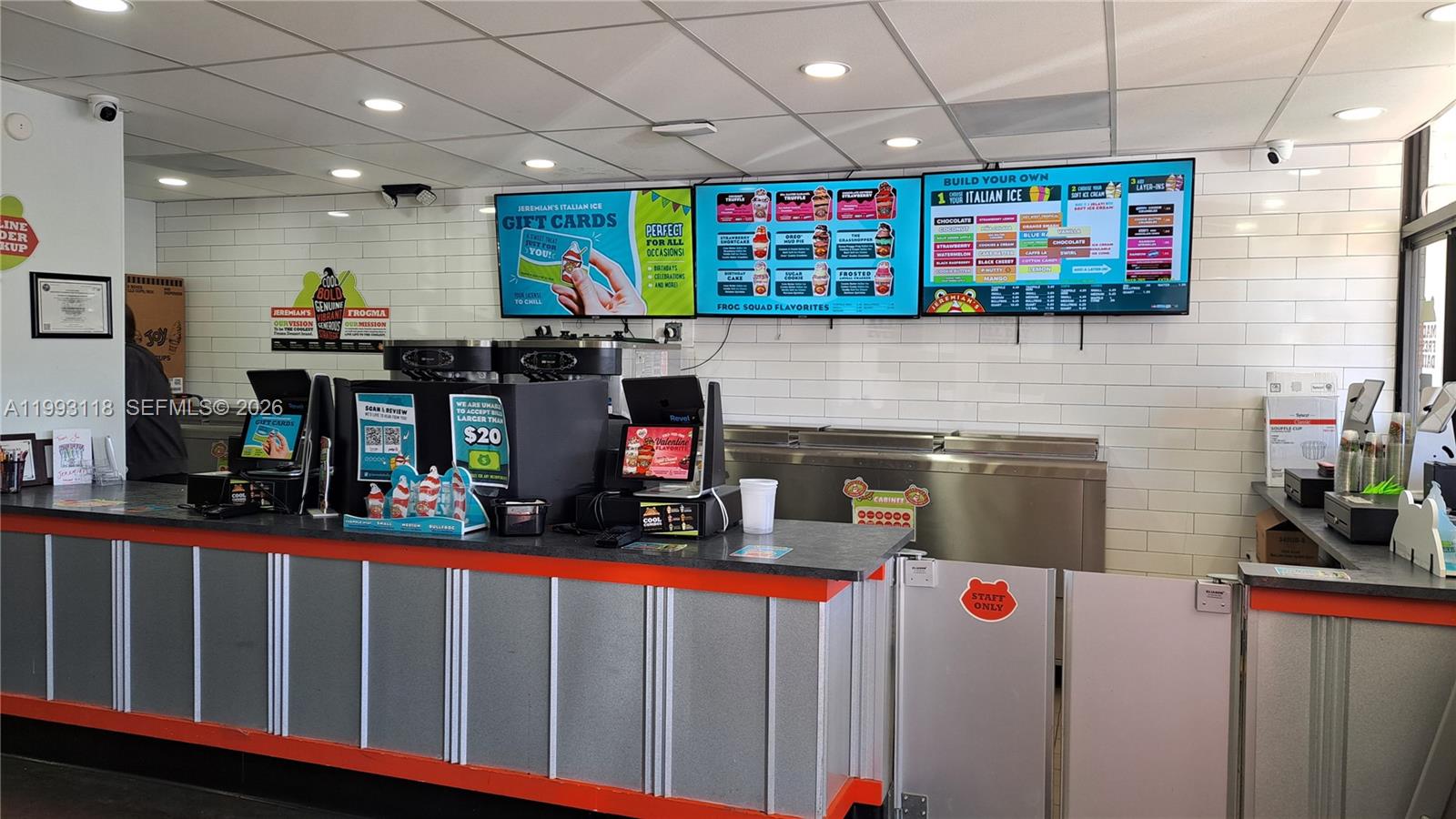 The interior of an ice cream shop features a service counter, digital menu boards, and tiling — 3650 N Federal Highway, Lighthouse Point FL 33060, LIGHTHOUSE POINT, FL