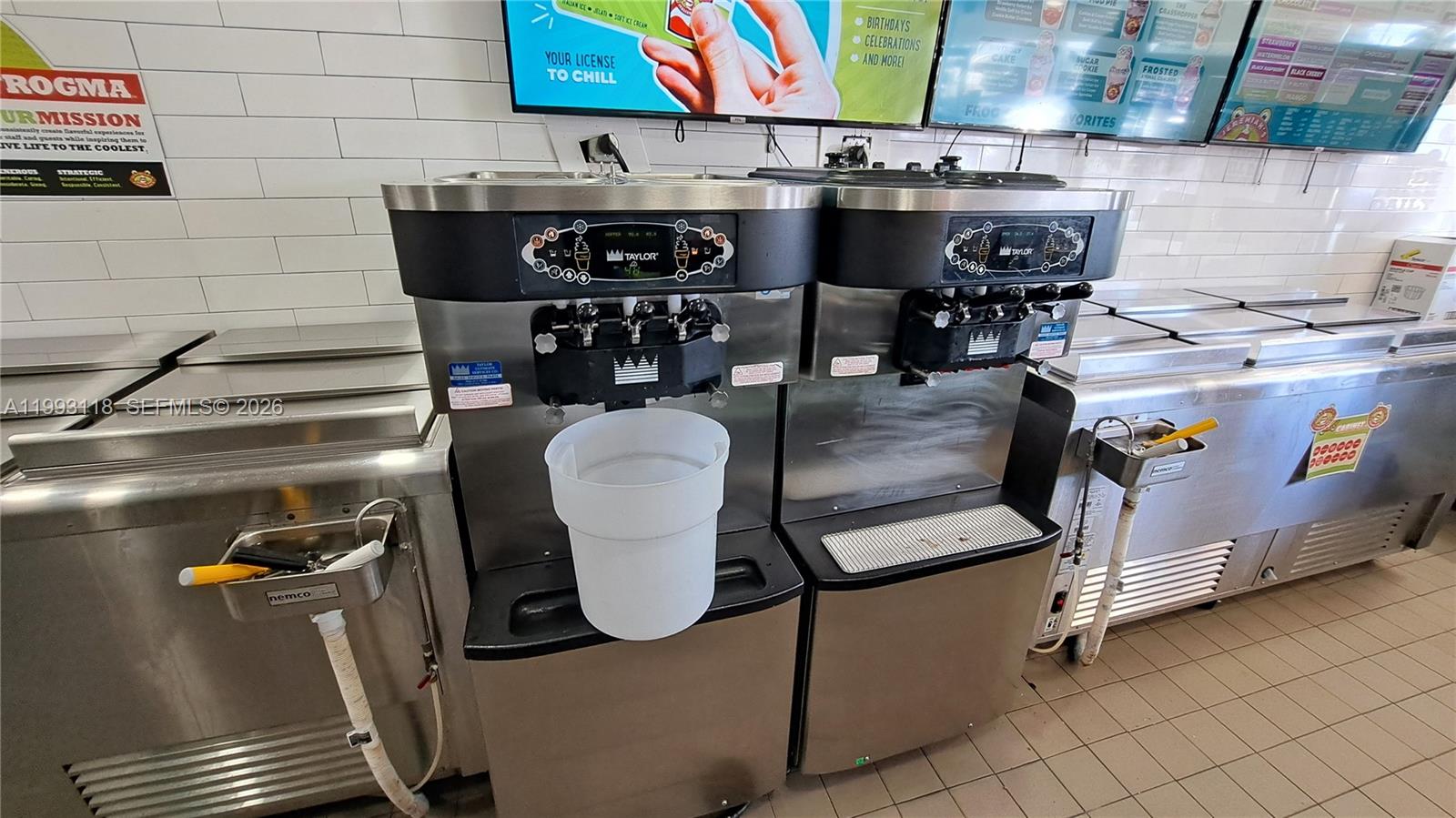 Two commercial soft-serve ice cream machines sit on a tiled floor against a white wall — 3650 N Federal Highway, Lighthouse Point FL 33060, LIGHTHOUSE POINT, FL