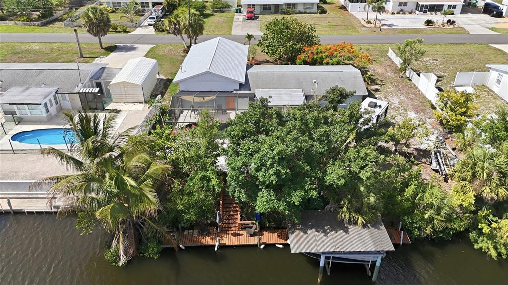 An aerial view of a waterfront house with a pool, deck, and boat dock — 852 E 6TH STREET, ENGLEWOOD, FL