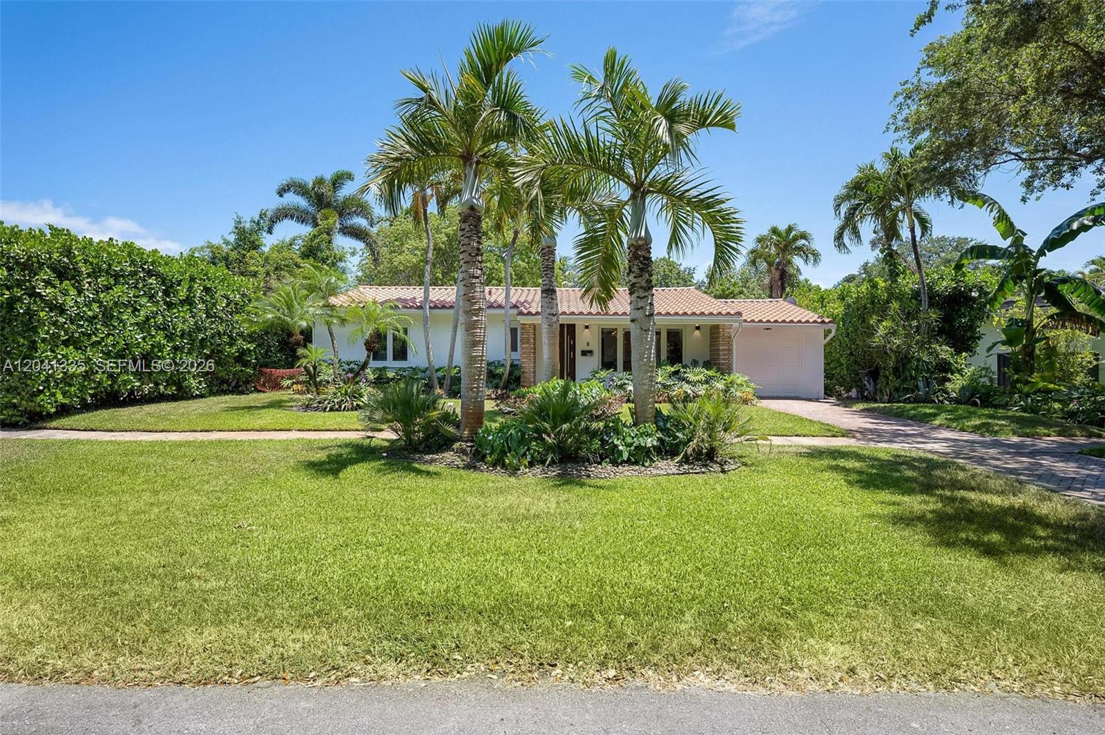 A single-story house with a tiled roof, palm trees, and a front lawn — 360 NE 91st St, Miami Shores FL 33138, MIAMI SHORES, FL