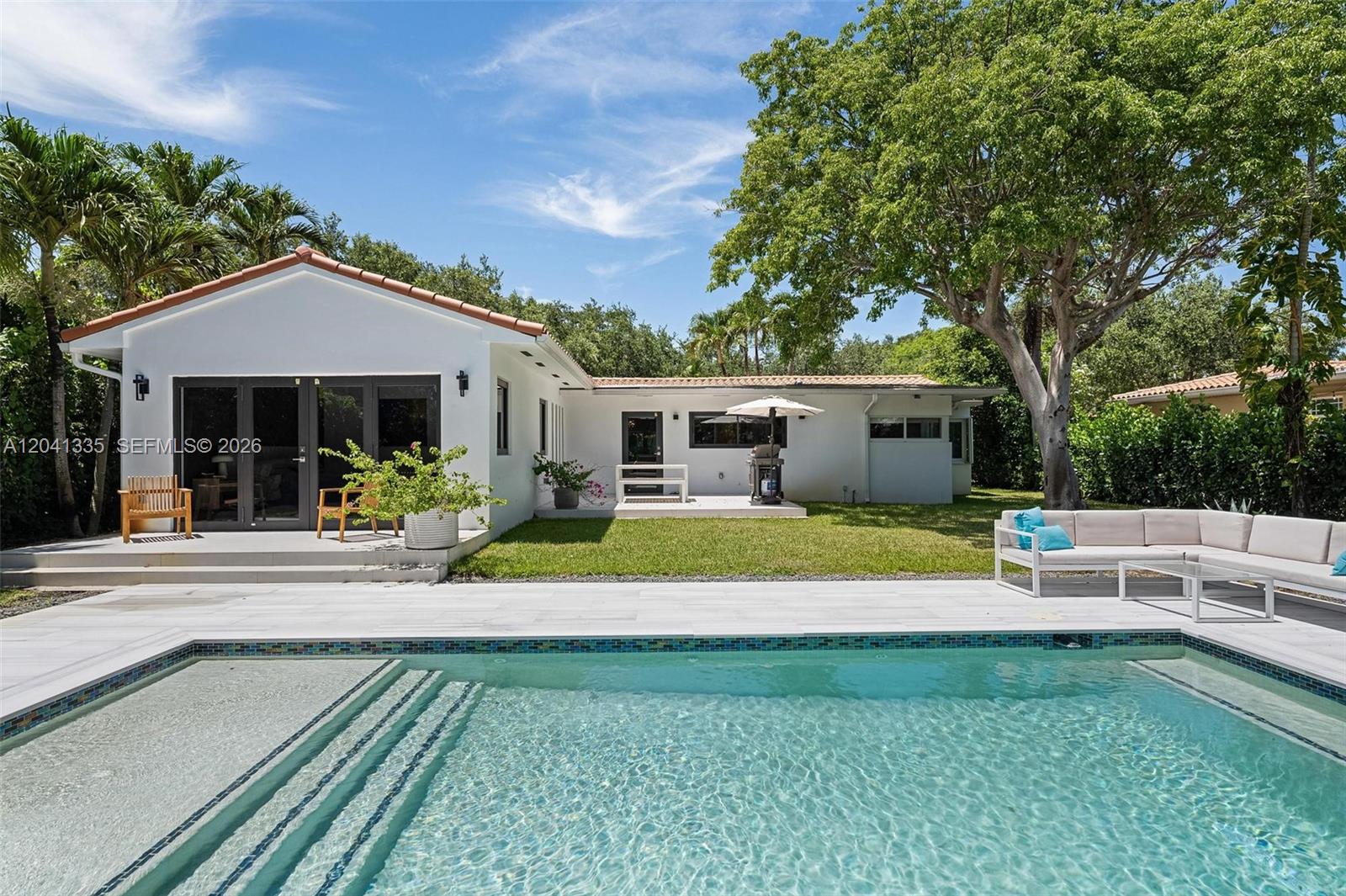 A white house with a swimming pool and patio area in the backyard — 360 NE 91st St, Miami Shores FL 33138, MIAMI SHORES, FL