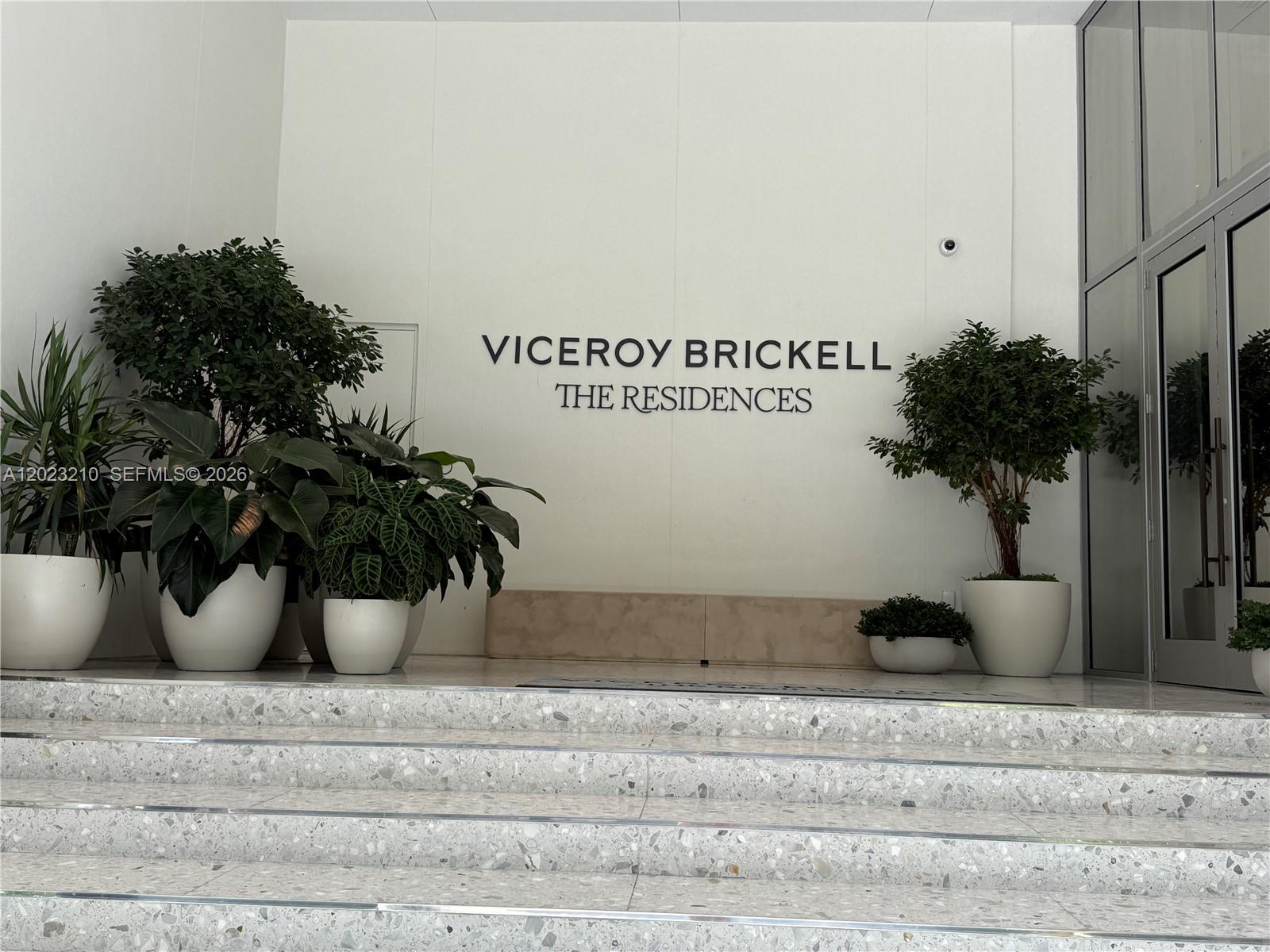 The entrance to Viceroy Brickell The Residences features stone steps leading to a white wall — 77 SE 5th ST # 2111, Miami FL 33131, MIAMI, FL