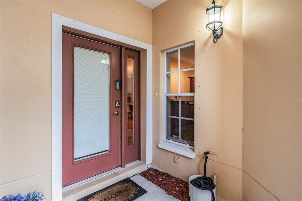 A front entryway features a red door with a glass panel and a nearby window — 415 BARCELONA DRIVE, ST PETERSBURG, FL