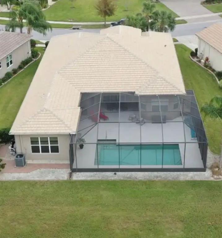 An aerial view of a house with a screened-in pool enclosure and a tiled roof — 16015 CAPE CORAL DRIVE, WIMAUMA, FL