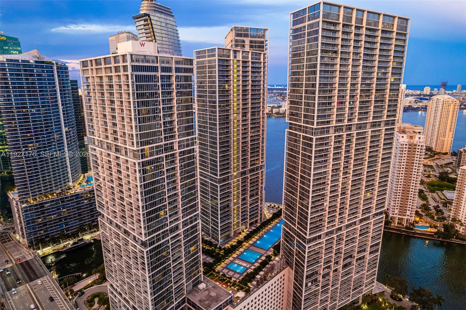An aerial view of three modern glass skyscrapers in Miami with a shared pool deck — 495 Brickell Ave # 2405, Miami FL 33131, MIAMI, FL