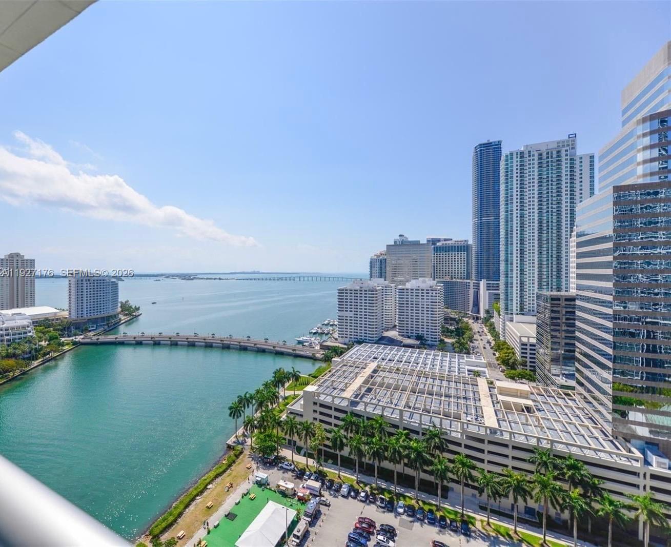 An elevated view of a city skyline, a bridge, and a bay under a clear sky — 495 Brickell Ave # 2405, Miami FL 33131, MIAMI, FL