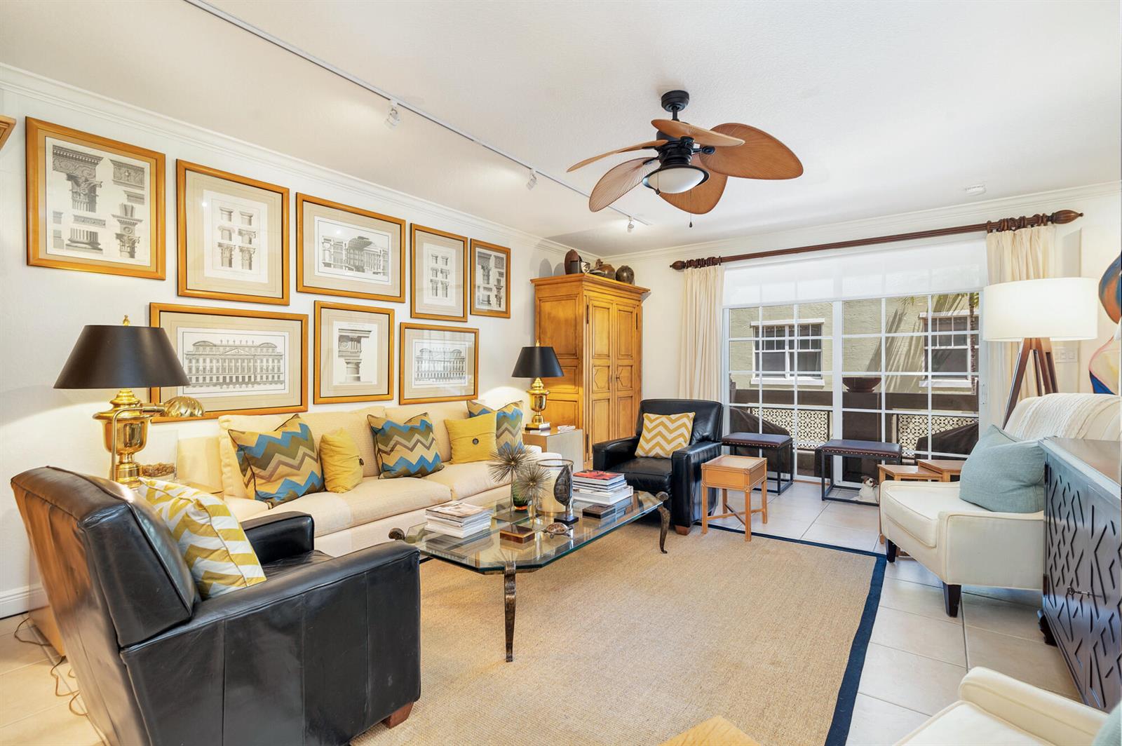 A living room features a beige sofa, two leather armchairs, a glass coffee table, and artwork — 219 N L Street # 111, FL 33460, FL