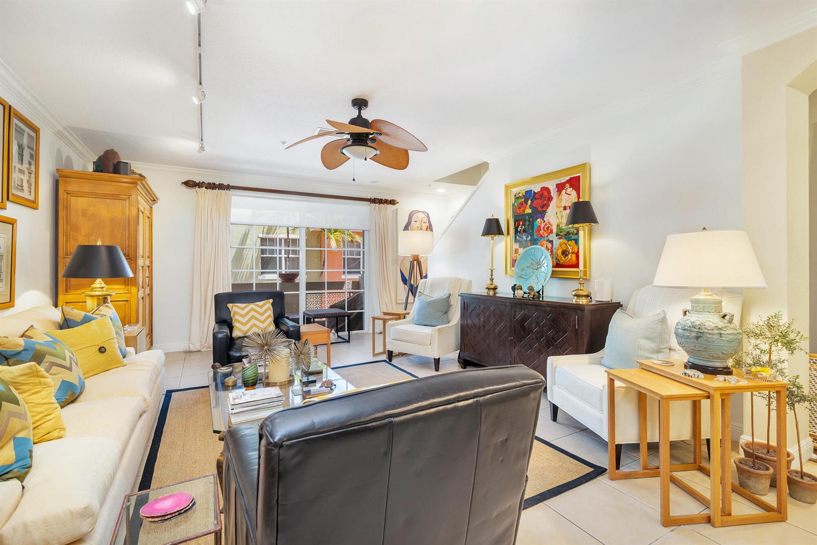 A living room features a sofa, armchairs, a dark wood cabinet, and a ceiling fan — 219 N L Street # 111, FL 33460, FL