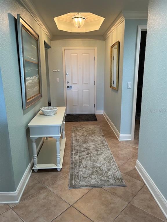An entryway features light blue walls, tile flooring, a white console table, and a ceiling light — 265 MINORCA BEACH WAY UNIT 304, NEW SMYRNA BEACH, FL