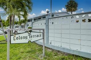 A sign for Colony Terrace stands in front of a white block wall and palm trees — 2020 NE 51st Ct # 203, Fort Lauderdale FL 33308, FORT LAUDERDALE, FL