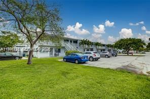 A two-story apartment building with a grassy lawn and parked cars in front — 2020 NE 51st Ct # 203, Fort Lauderdale FL 33308, FORT LAUDERDALE, FL