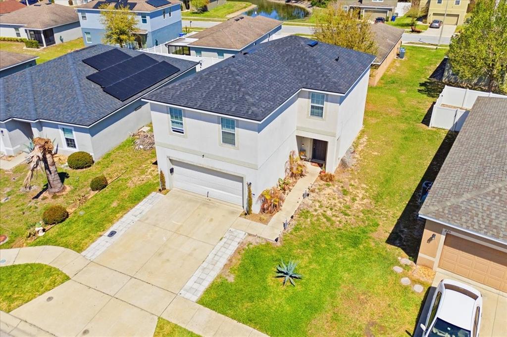 An aerial view shows a two-story suburban house with a gray roof and garage — 231 HAINES BOULEVARD, WINTER HAVEN, FL