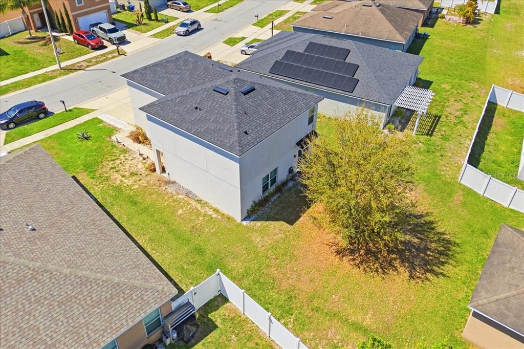 An aerial view shows a two-story house with a gray roof and a backyard tree — 231 HAINES BOULEVARD, WINTER HAVEN, FL