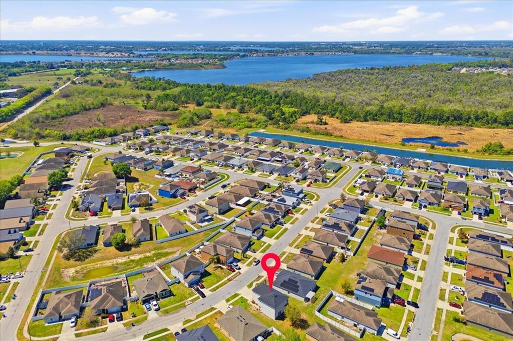 An aerial view shows a suburban neighborhood with a red pin marking a specific house — 231 HAINES BOULEVARD, WINTER HAVEN, FL