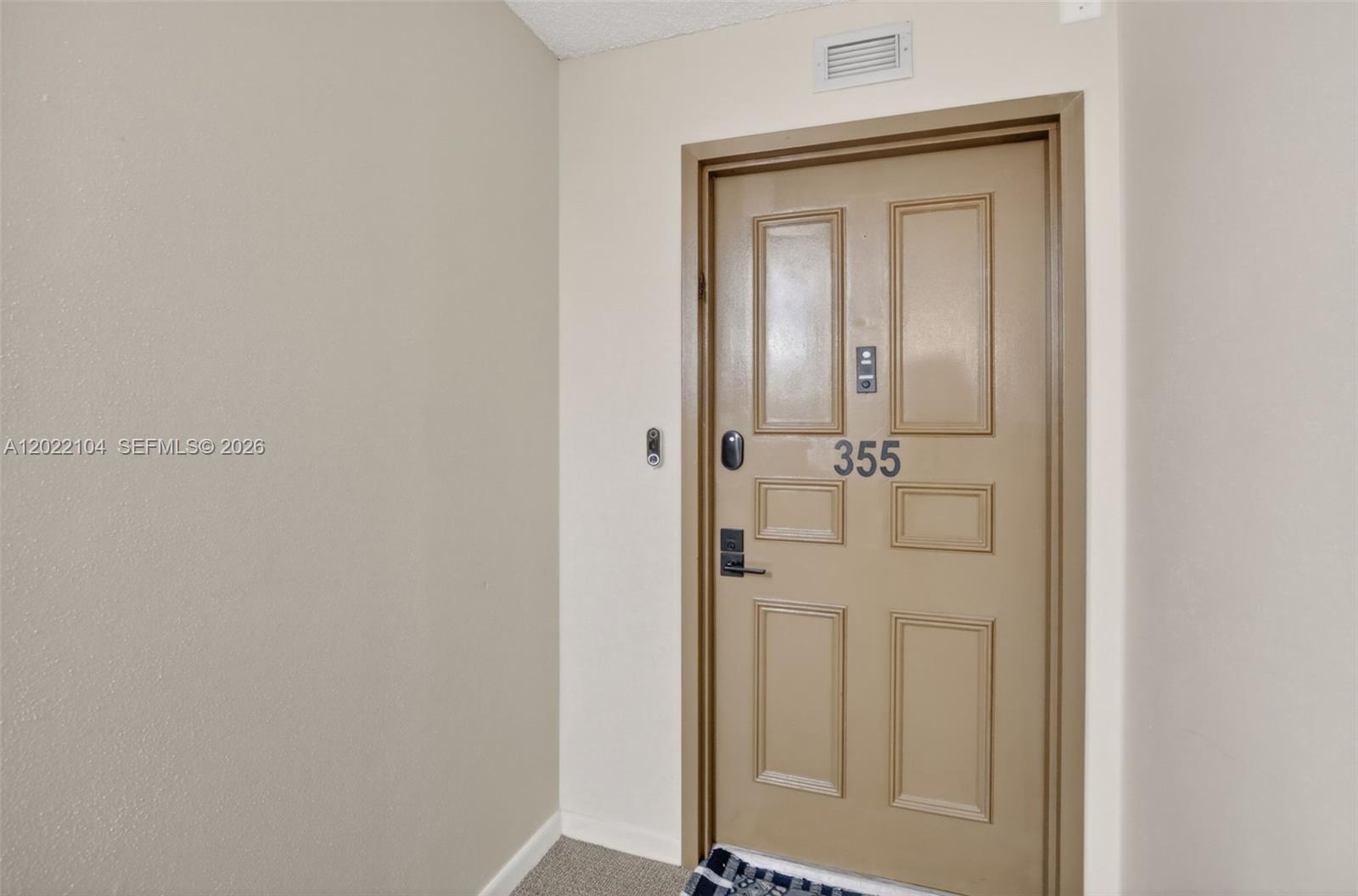 A beige door numbered 355 is set into a plain wall with carpeted flooring — 3771 Environ Blvd # 355, Lauderhill FL 33319, LAUDERHILL, FL
