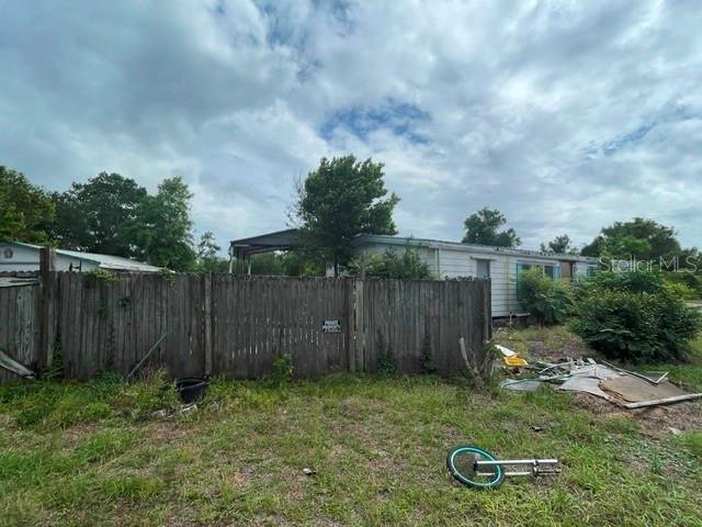 An outdoor view shows a small, weathered building with a concrete pad and orange traffic cones — 12024 LAKEVIEW DRIVE, LEESBURG, FL