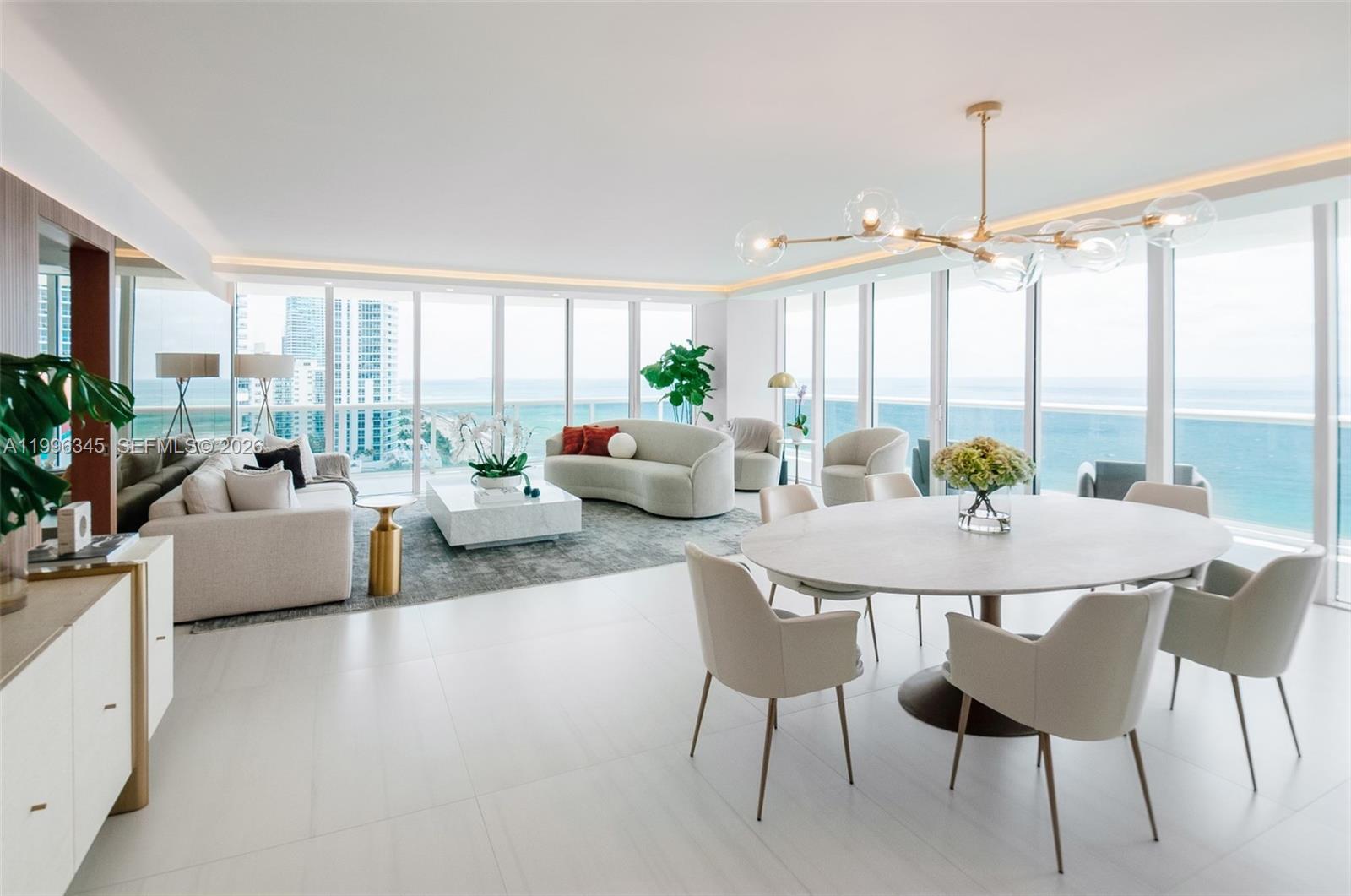 A bright, open-concept living and dining area features floor-to-ceiling windows with ocean views — 1830 S Ocean Dr # 1501, Hallandale Beach FL 33009, HALLANDALE BEACH, FL