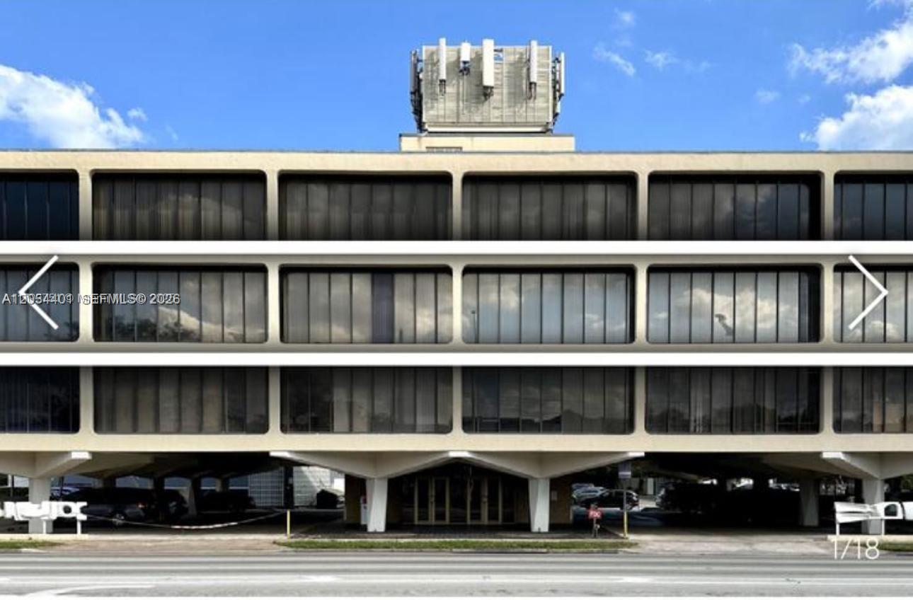 A three-story commercial building with a ground-level parking area and a rooftop telecommunications structure — 420 S Dixie Hwy, Coral Gables FL 33146, CORAL GABLES, FL