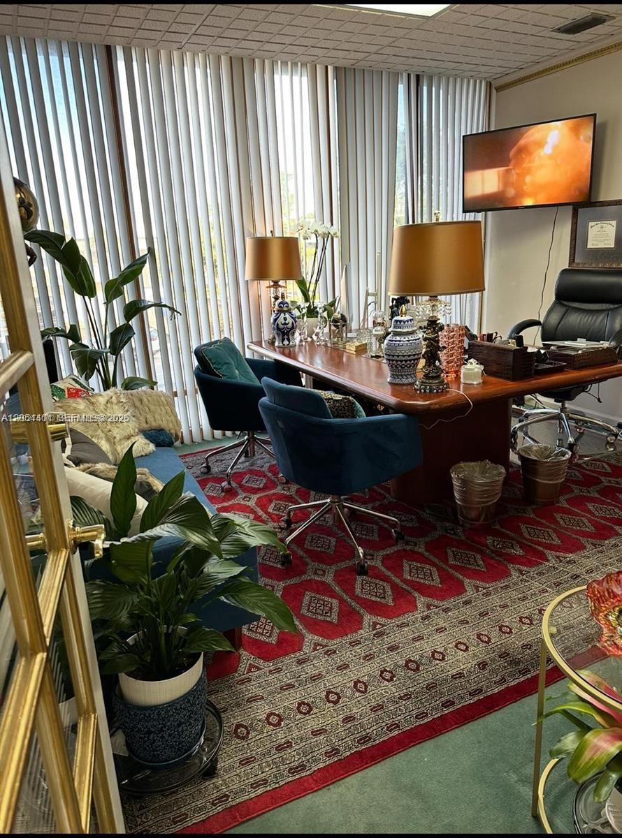 An office with a large wooden desk, blue chairs, and a red patterned area rug — 420 S Dixie Hwy, Coral Gables FL 33146, CORAL GABLES, FL