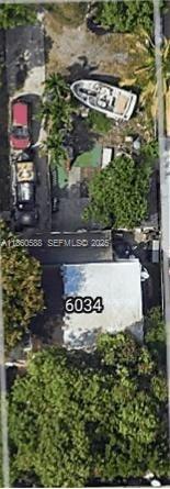 This aerial view shows a residential property with a house, driveway, and a boat — 6034 Fillmore St, Hollywood FL 33024, HOLLYWOOD, FL