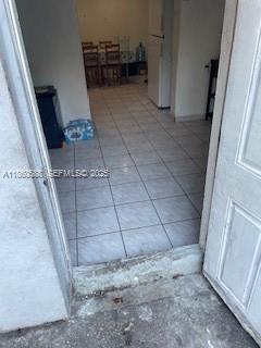 A view through an open doorway into a tiled room with a dining set — 6034 Fillmore St, Hollywood FL 33024, HOLLYWOOD, FL