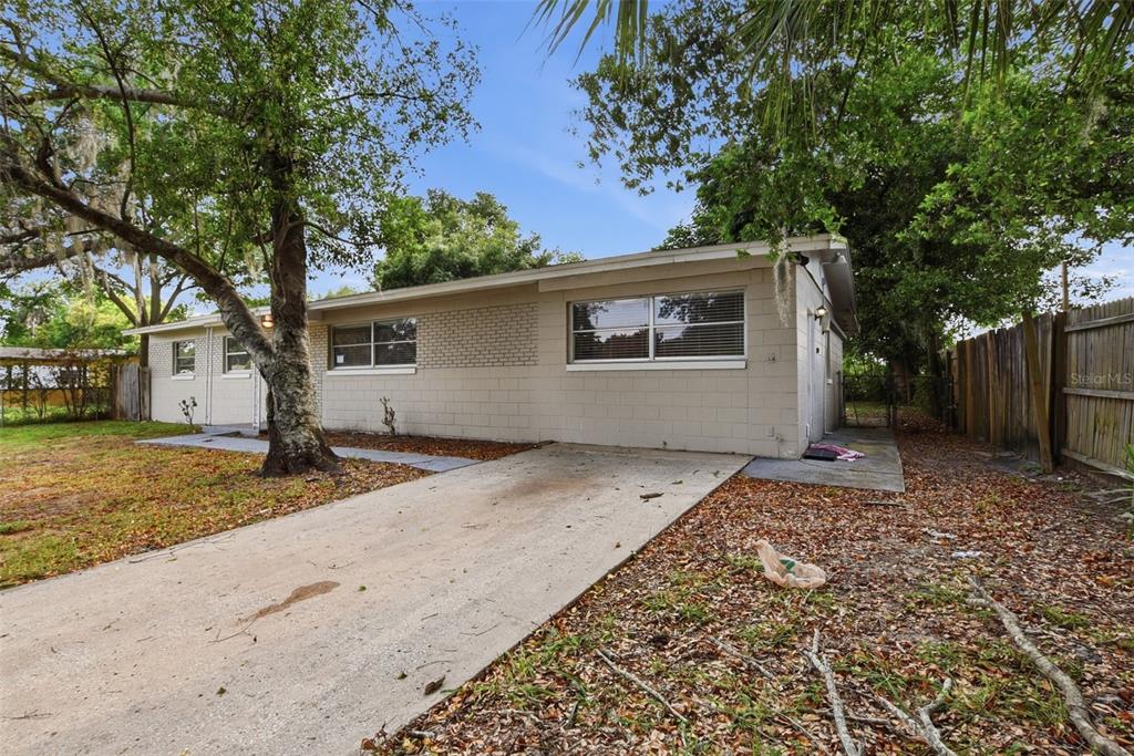 A single-story house with a concrete block exterior and a concrete driveway — 4132 WESTGATE ROAD, ORLANDO, FL