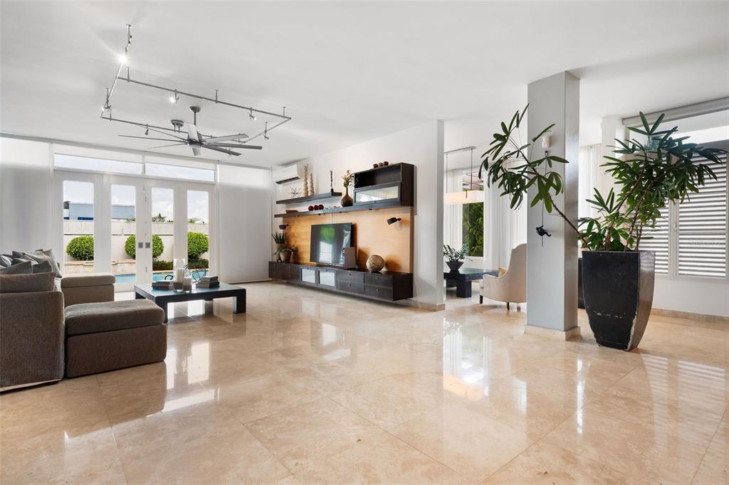 A spacious living room features large beige floor tiles, a media wall, and glass doors — PR 8860 km 1.6 KM  1.6, TRUJILLO ALTO, PR