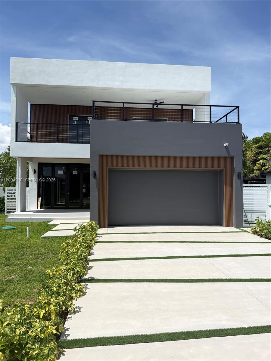 A modern two-story house features a gray garage, white exterior walls, and a balcony railing — 6449 SW 28th St, Miami FL 33155, MIAMI, FL