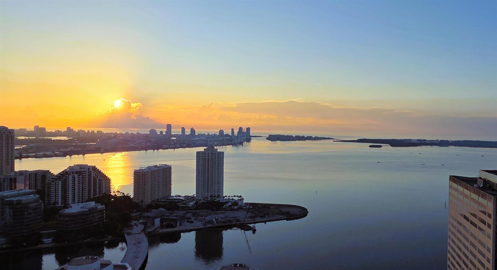 An aerial view of a coastal city skyline and bay at sunset — 951 Brickell Avenue # 4308, Miami FL 33131, MIAMI, FL