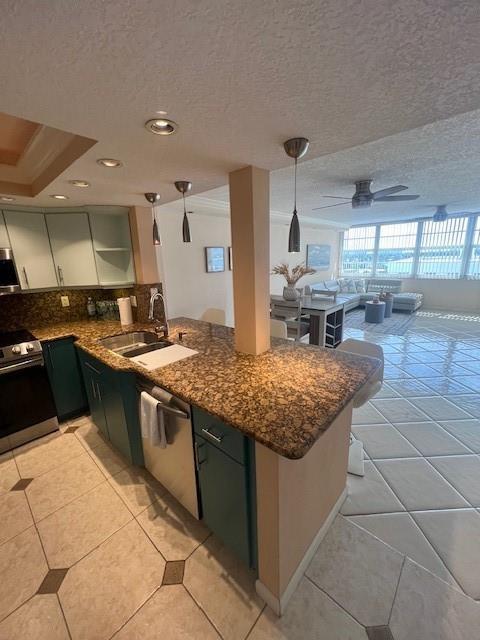 A kitchen with teal cabinets and granite countertops opens into a bright living area — 1160 N Federal Highway # 1118, Fort Lauderdale FL 33304, FORT LAUDERDALE, FL