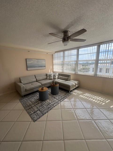 A living room features a light gray sectional sofa, two round tables, and tile flooring — 1160 N Federal Highway # 1118, Fort Lauderdale FL 33304, FORT LAUDERDALE, FL