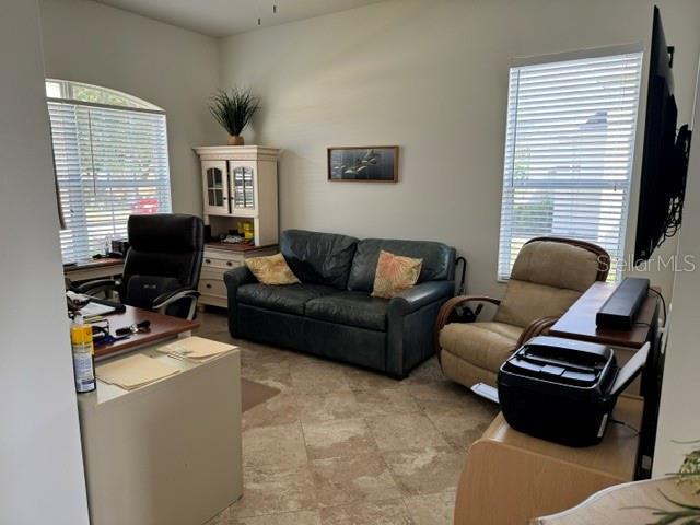 A home office features a desk, a dark leather sofa, a recliner, and a printer — 6145 E 41 STREET, BRADENTON, FL