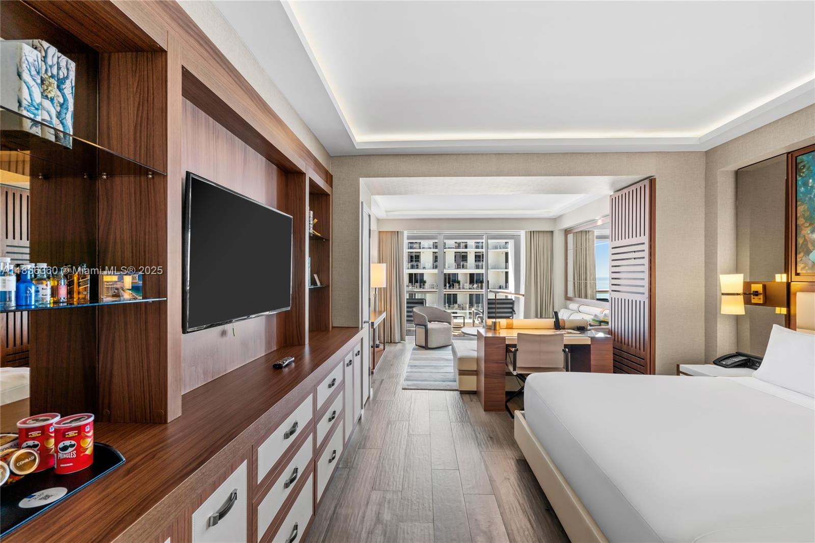 A modern hotel room features a bed, a desk, a television, and a balcony view — 551 N Fort Lauderdale Beach Blvd # R1909, Fort Lauderdale FL 33304, FORT LAUDERDALE, FL