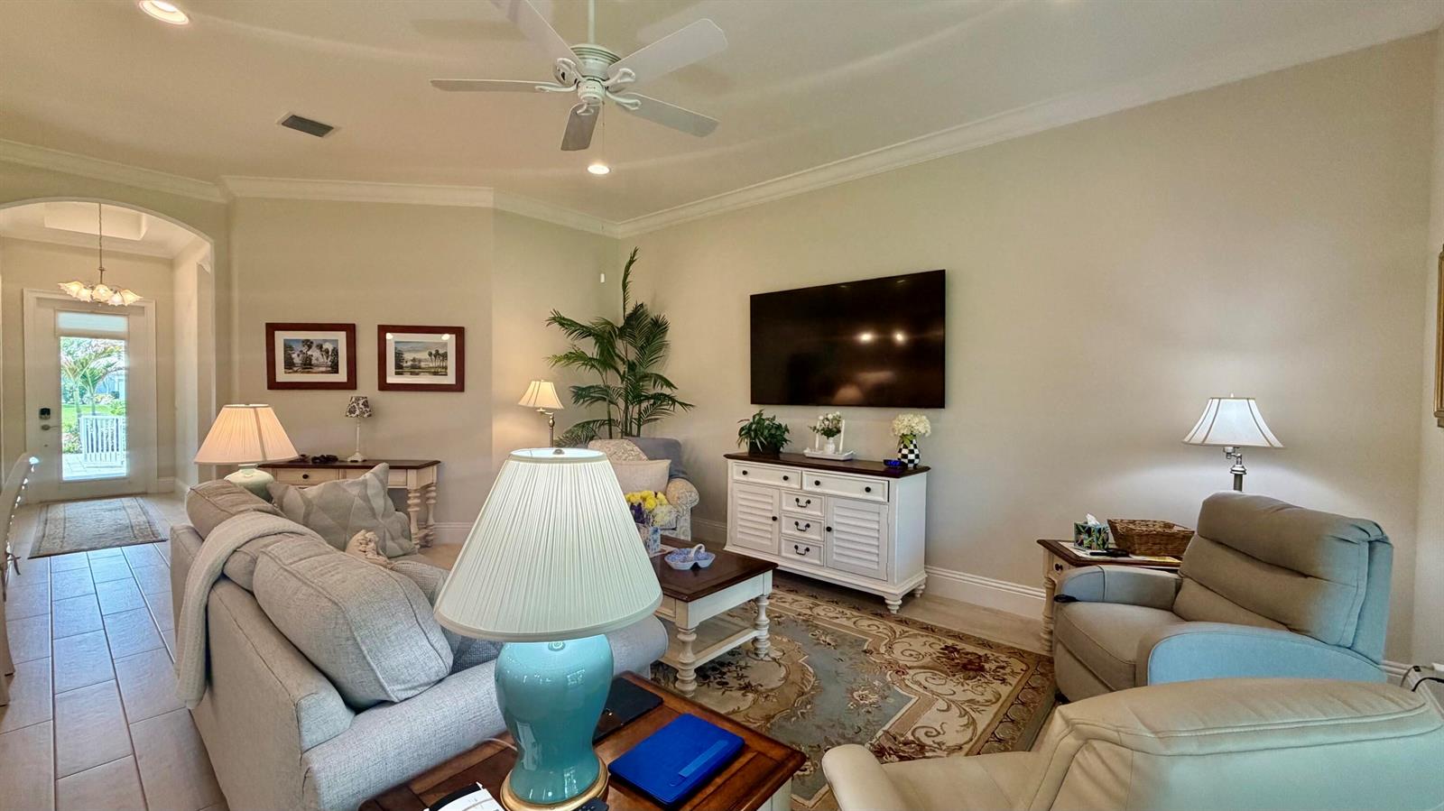 A living room features a sofa, two armchairs, a television, and a ceiling fan — 1330 St Catherine's Circle, Vero Beach FL 32967, VERO BEACH, FL