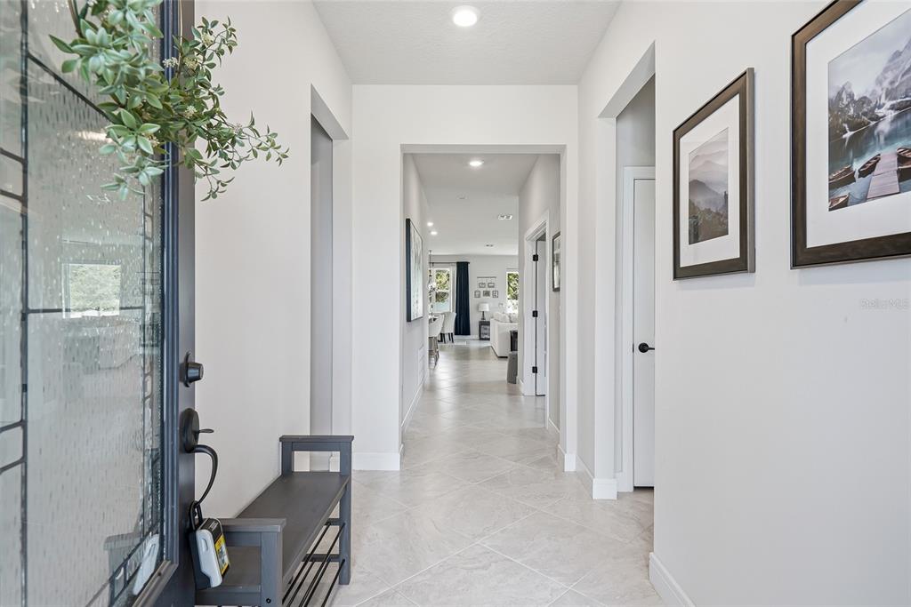 A bright entryway features light tile flooring, white walls, and a view into the home — 4678 DOVER BLUFF COURT, VALRICO, FL