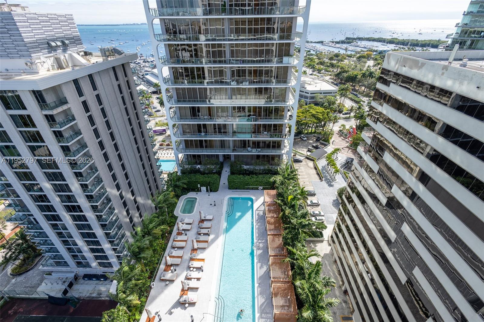 An aerial view shows a swimming pool and lounge area between three high-rise buildings — 2678 Tigertail Ave # 612, Miami FL 33133, MIAMI, FL