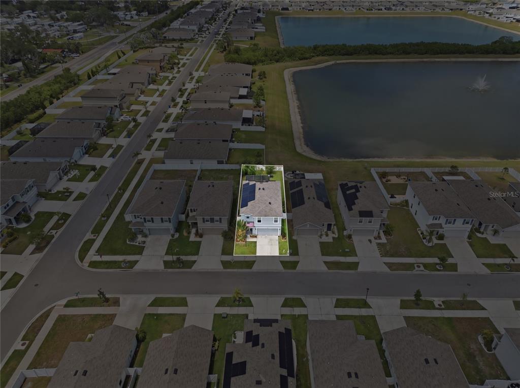 An aerial view shows a single-family home with solar panels on its roof — 440 OLIVE CONCH STREET, RUSKIN, FL