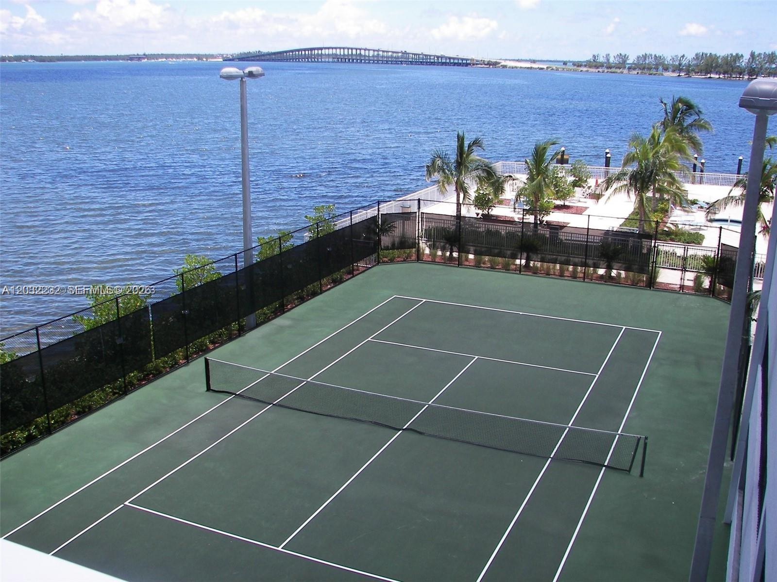 An elevated view shows a green tennis court beside a body of water and bridge — 2101 Brickell Ave # 2402, Miami FL 33129, MIAMI, FL