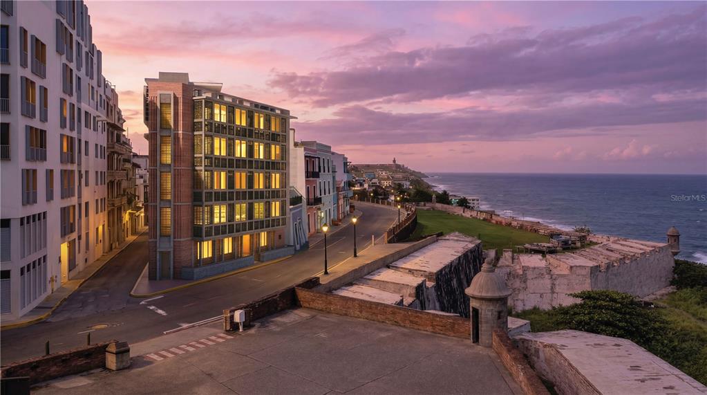 This is a rendering of a multi-story building overlooking a historic stone fort and ocean — 425 SOL STREET UNIT Penthouse, SAN JUAN, PR