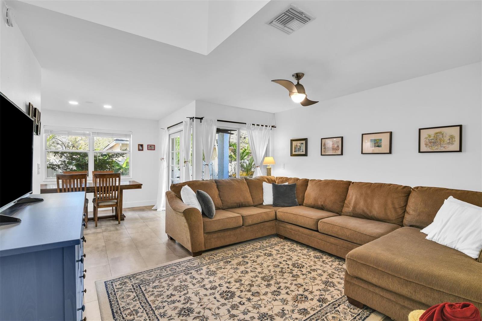 A living room features a large brown sectional sofa, a patterned rug, and dining area — 843 NW 98th Avenue, Plantation FL 33324, PLANTATION, FL