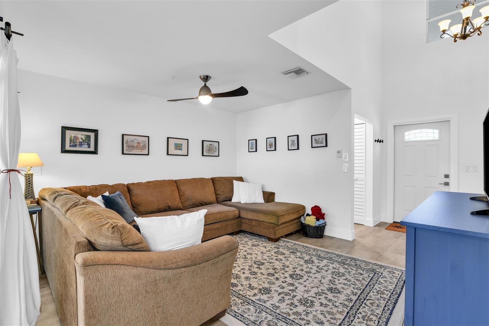 A living room features a brown sectional sofa, a patterned area rug, and a ceiling fan — 843 NW 98th Avenue, Plantation FL 33324, PLANTATION, FL