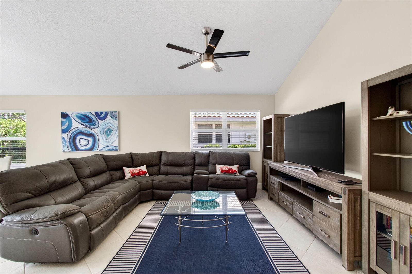 A living room features a large gray sectional sofa, a glass coffee table, and television — 2034 NW 52nd Street, Boca Raton FL 33496, BOCA RATON, FL