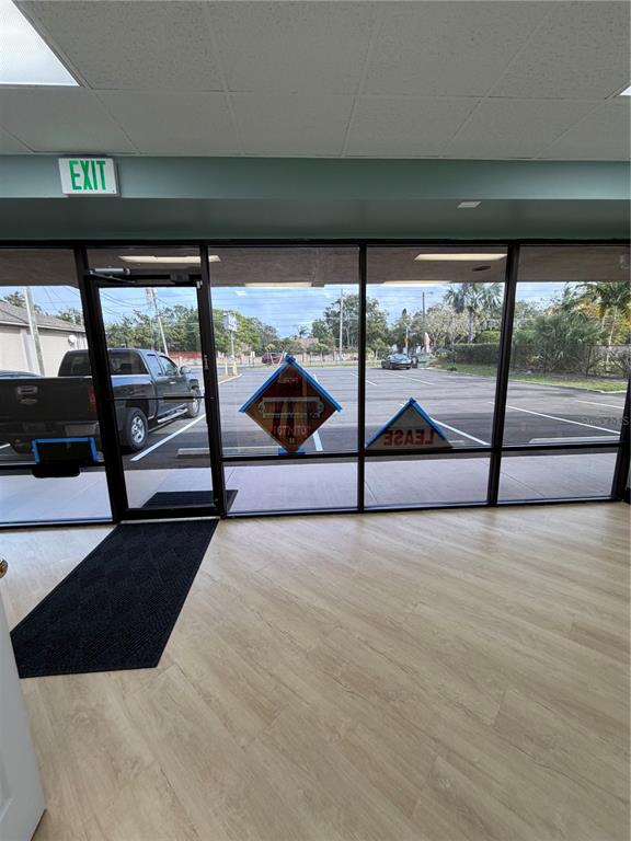 An interior view of a commercial space looking out through large windows at a parking lot — 4950 HALL UNIT B, ORLANDO, FL