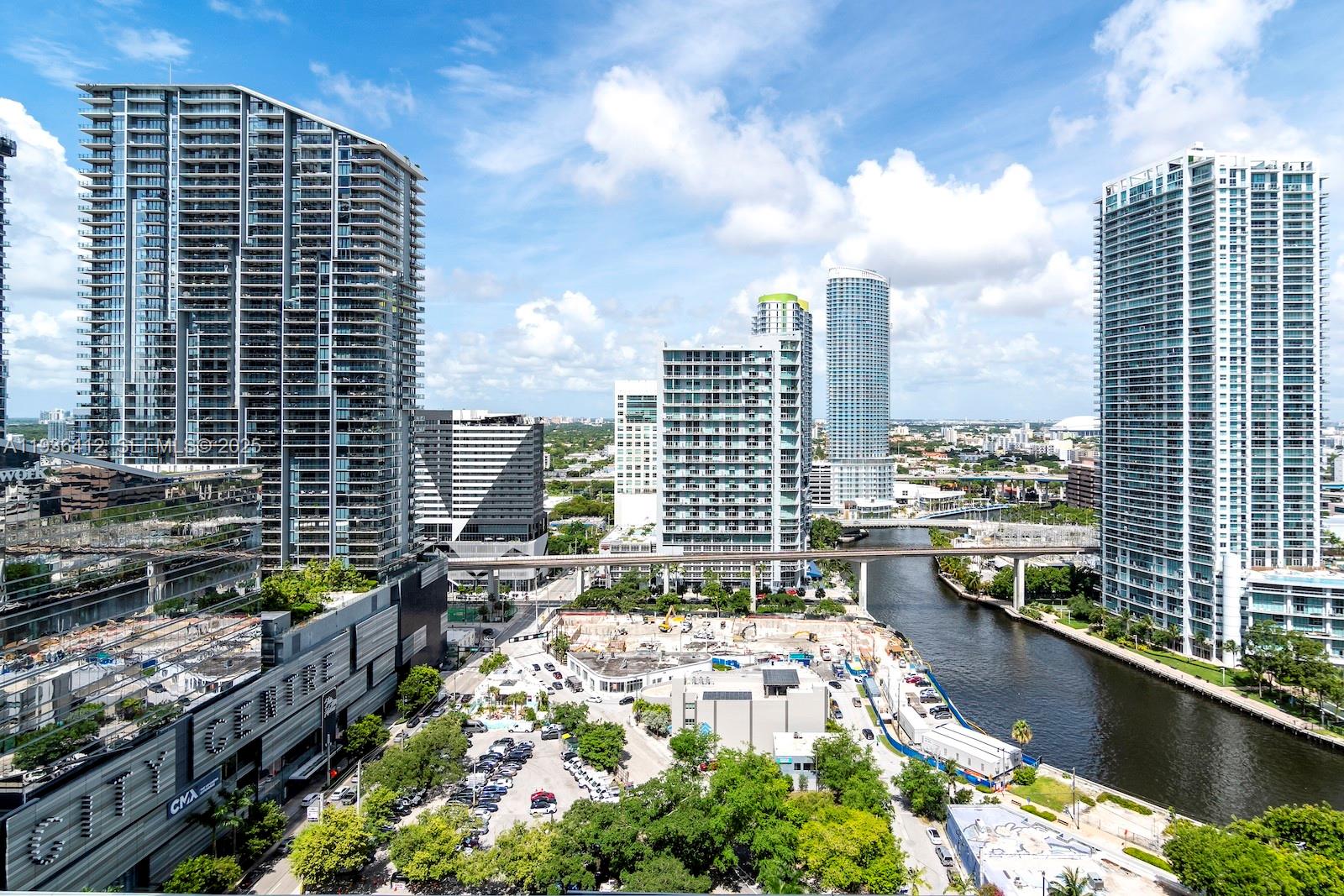 An elevated view of a Miami cityscape featuring modern high-rise buildings, a river, and construction — 68 SE 6th St # 2010, Miami FL 33131, MIAMI, FL