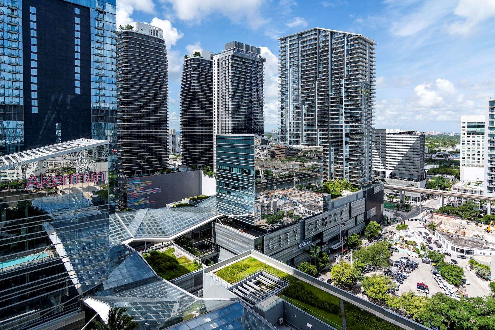 An elevated view of the Brickell City Centre complex featuring modern glass skyscrapers and greenery — 68 SE 6th St # 2010, Miami FL 33131, MIAMI, FL