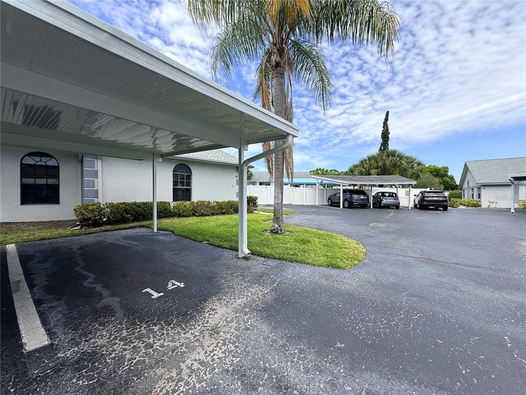 A covered parking space marked with the number 14 sits beside a building exterior — 2749 COUNTRYSIDE BOULEVARD UNIT 14, CLEARWATER, FL