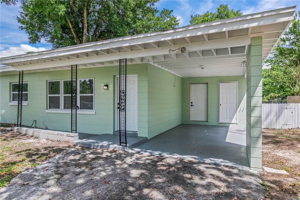 A bright, empty living room features white walls, recessed lighting, and light wood-look flooring — 1435 EDEN DRIVE, APOPKA, FL