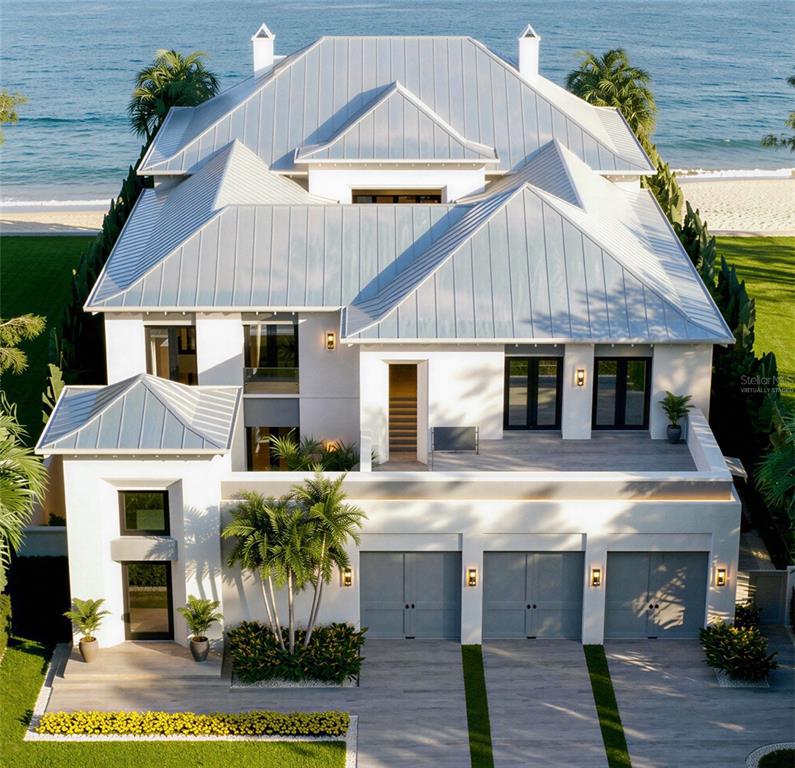 This is a rendering of a two-story beachfront house with a metal roof and balcony — 620 GULF BOULEVARD, BELLEAIR SHORE, FL
