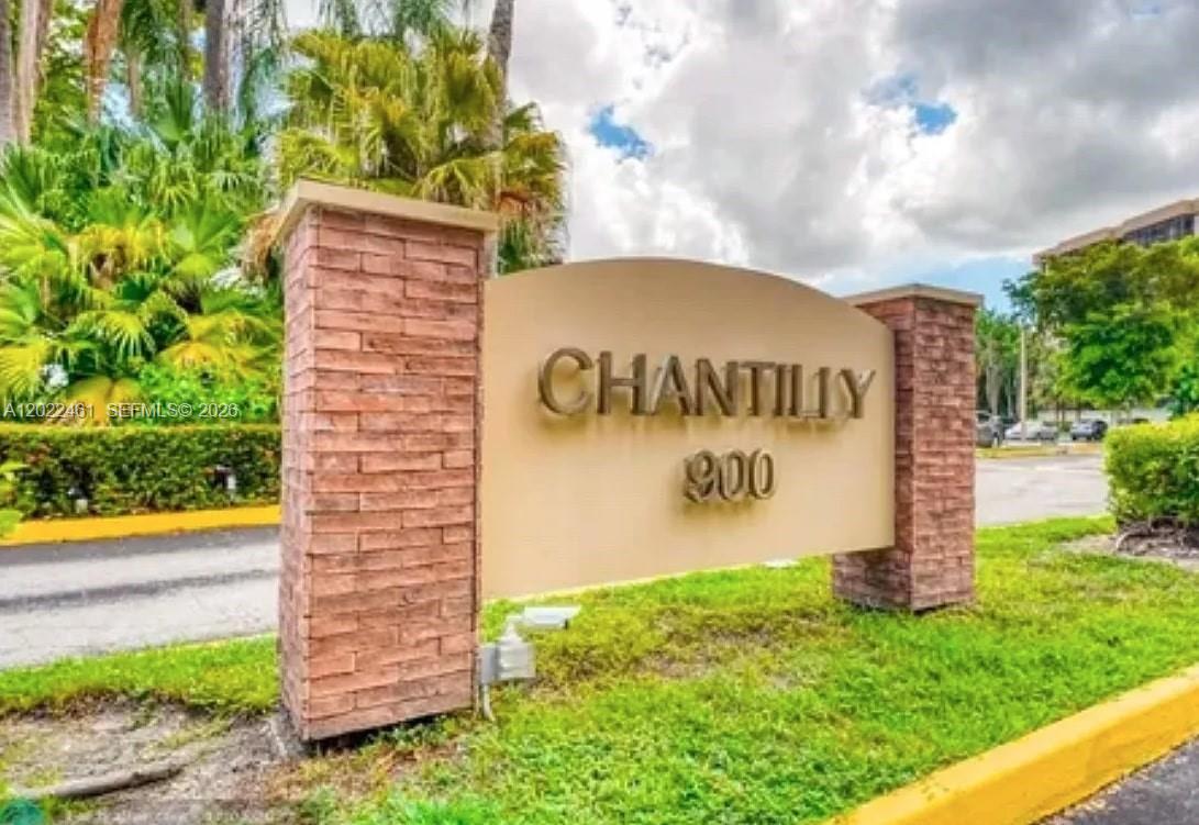A brick-columned monument sign displays the name Chantilly and the number 900 outdoors — 900 NE 195th St # 618, Miami FL 33179, MIAMI, FL